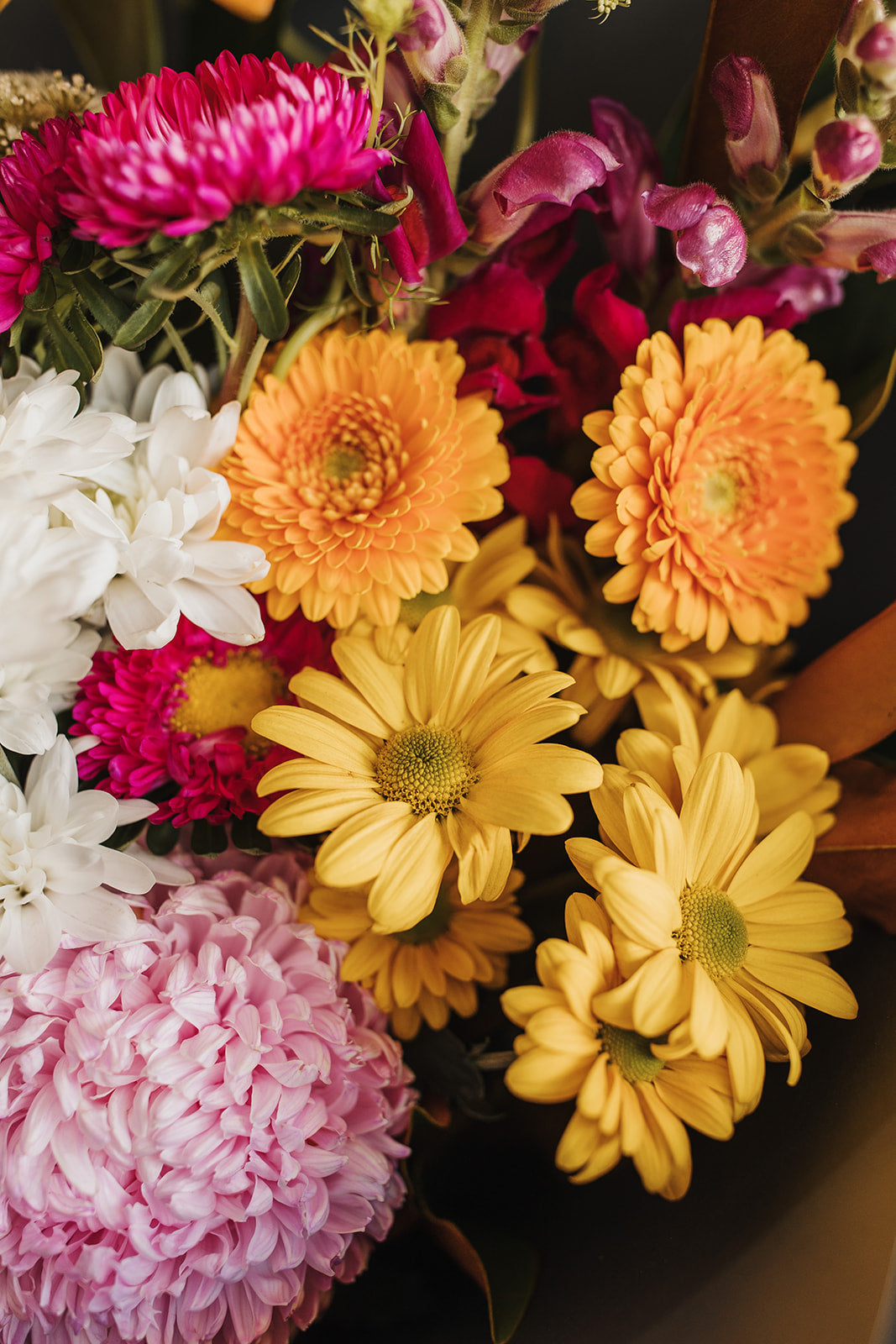 Up close view of bright colour bouquet showing snapdragons, gerberas and chrysanthemums. Clare florist that offers local delivery.