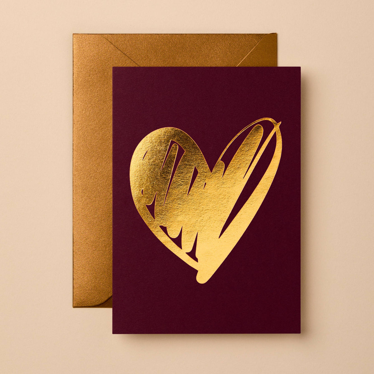 Gold foil heart on burgundy card