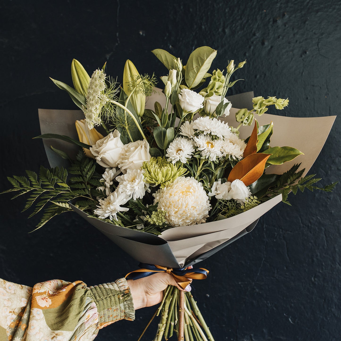 Clare florist with local delivery. Mixed bouquet of flowers in neutral tones of white and green including lillies, lisianthus, roses and chrysanthemums. 