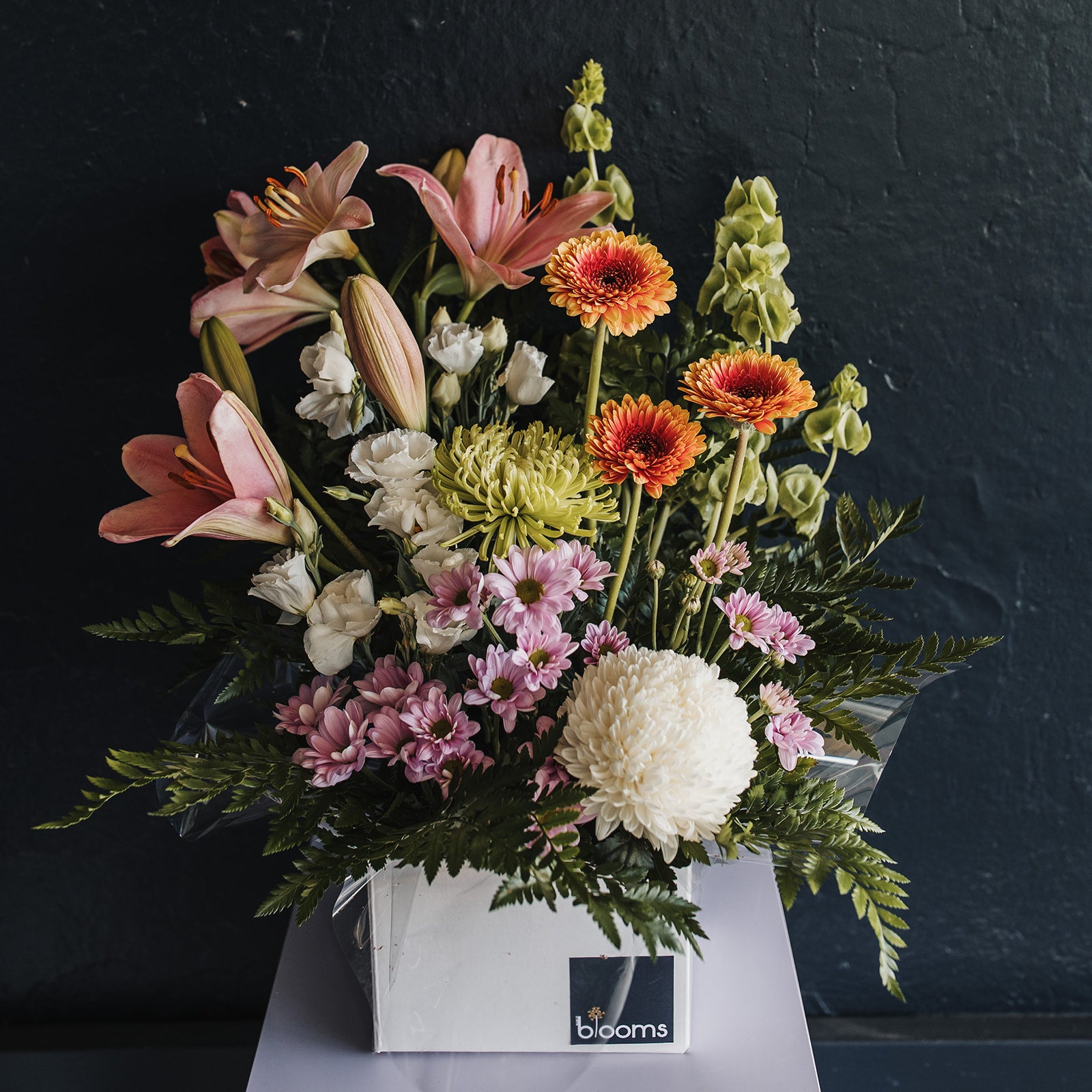 Clare Valley flower delivery showing a Bloom Box arrangement with bright flowers including lillies, lisianthus, gerberas and chrysanthemums.